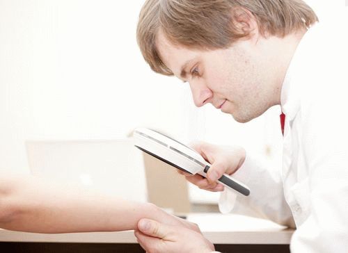 Врач осматривает кожу